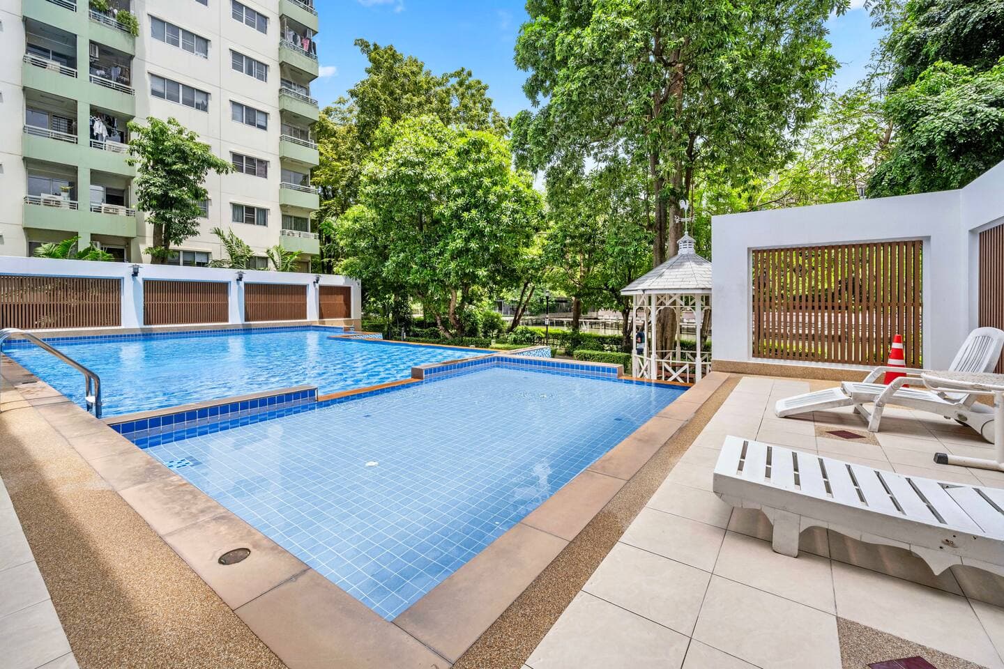 Sparkling pool and sun loungers for residents at Bangkok River Oasis