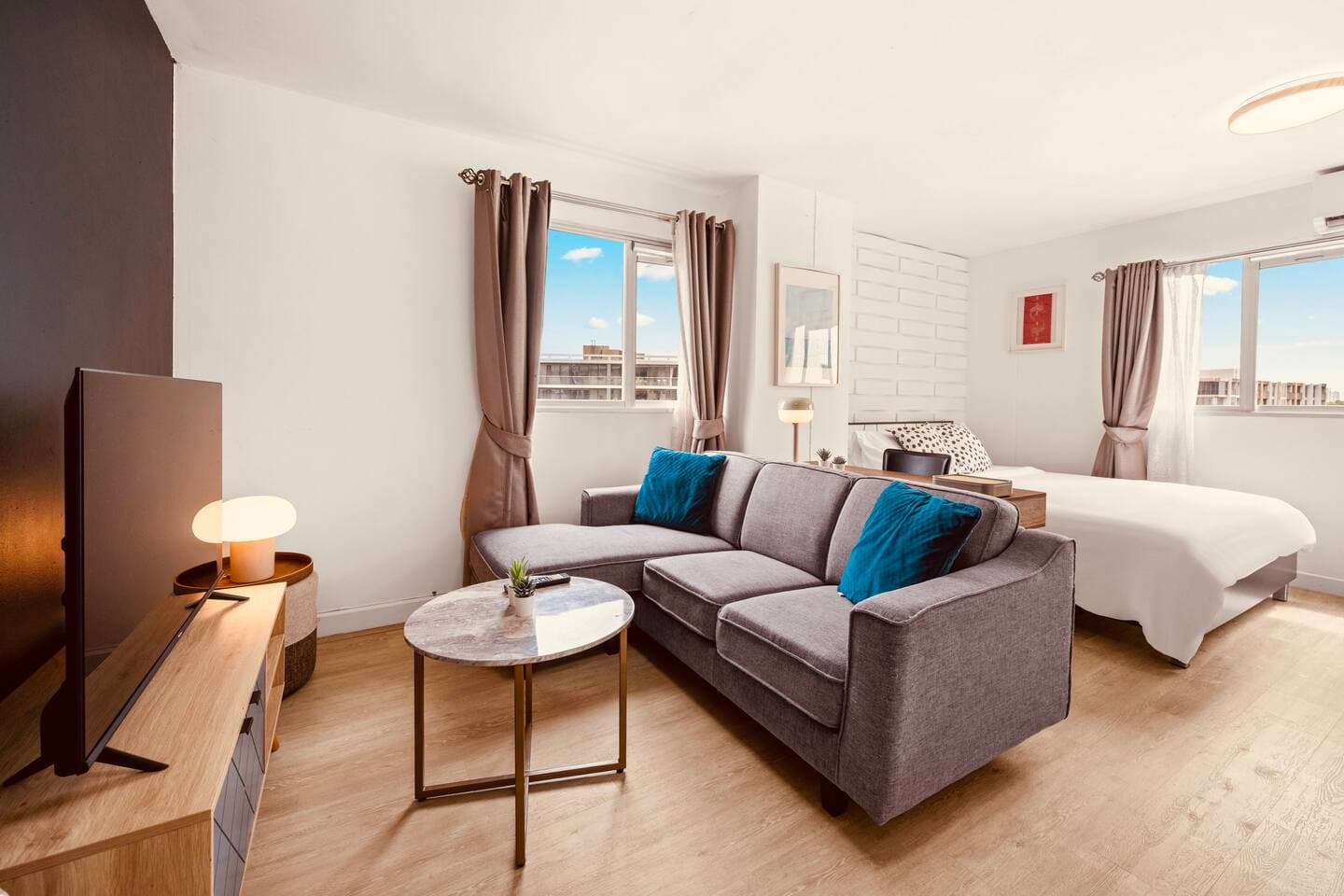 Bright living room with comfortable sofa and city views – Sukhumvit 77 Condo