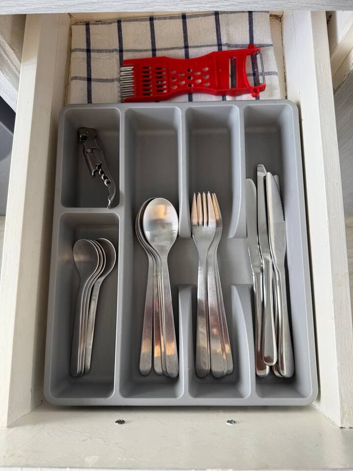 Stocked cutlery drawer and kitchen utensils provided for guests