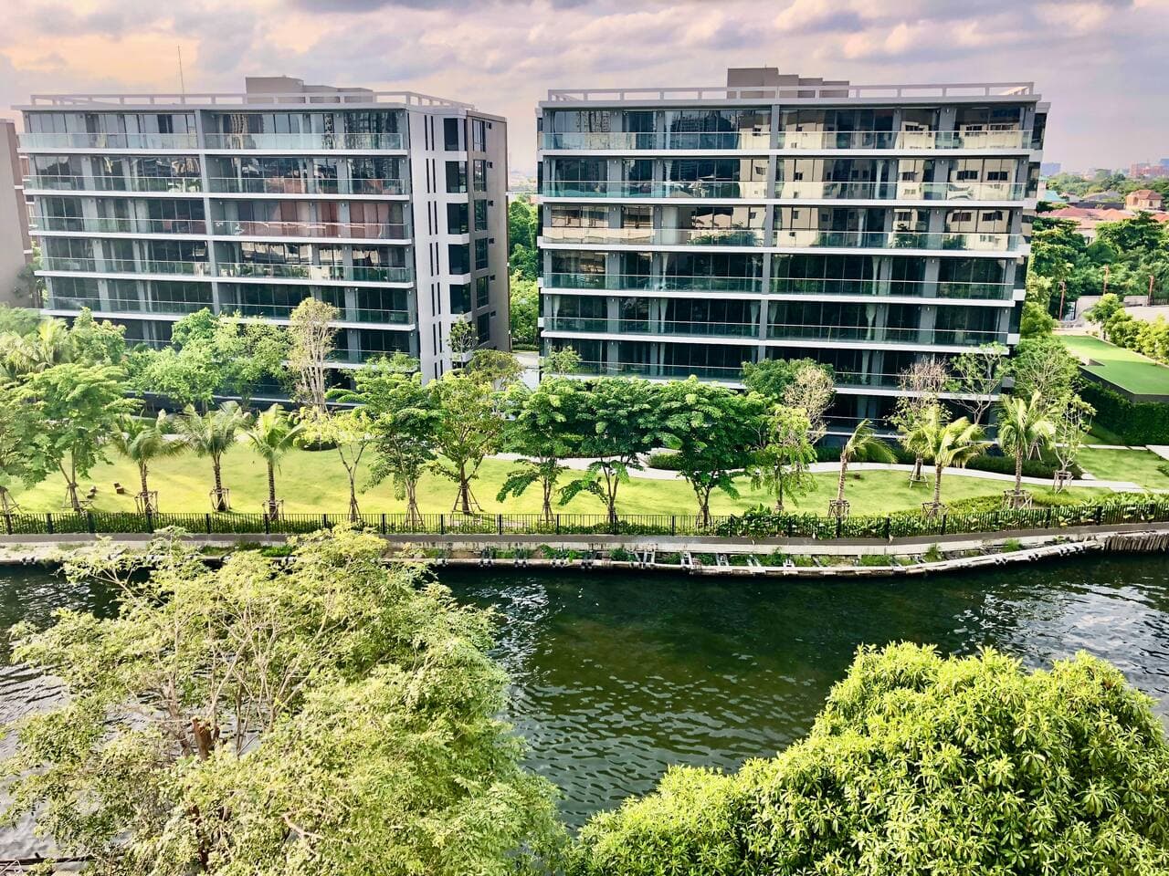 Exterior view of the modern condo complex overlooking the Phrakanong River