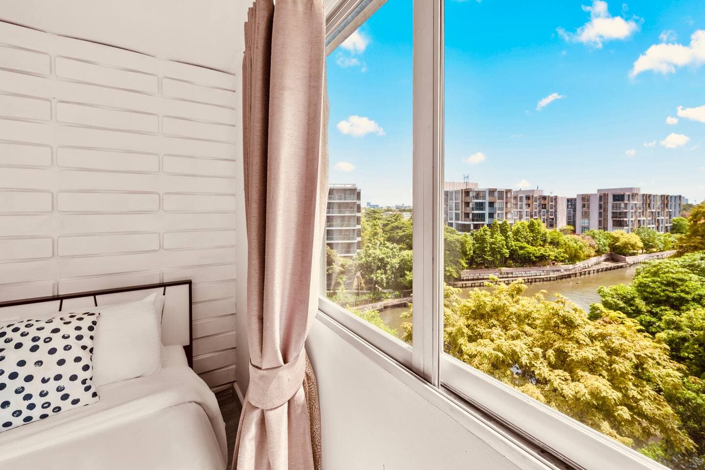 High-floor view showing the Phrakanong River and Bangkok skyline