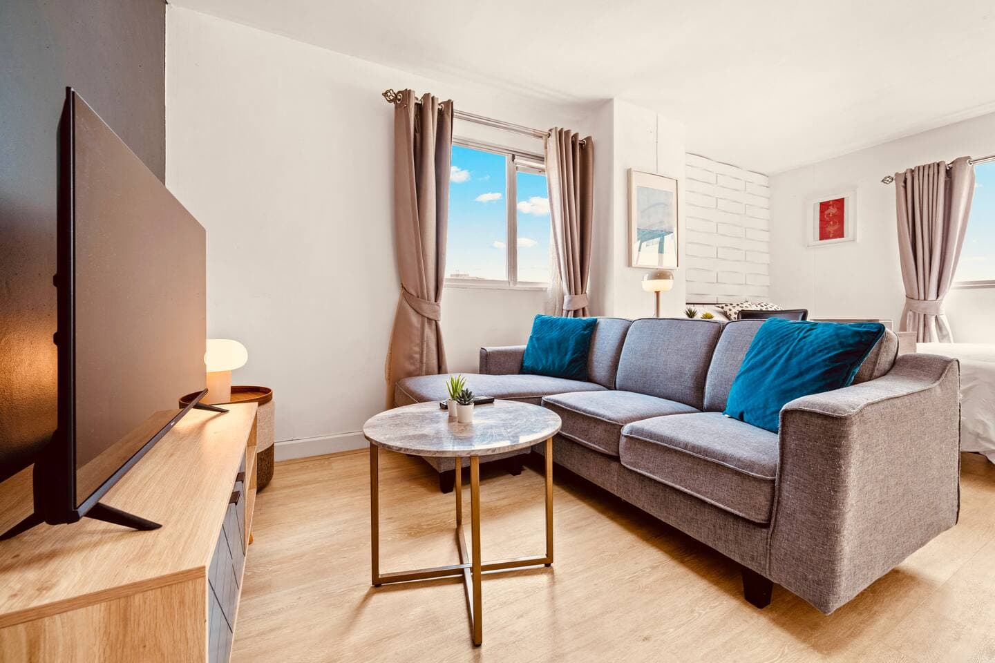 Comfortable lounge space with large windows and afternoon sunlight