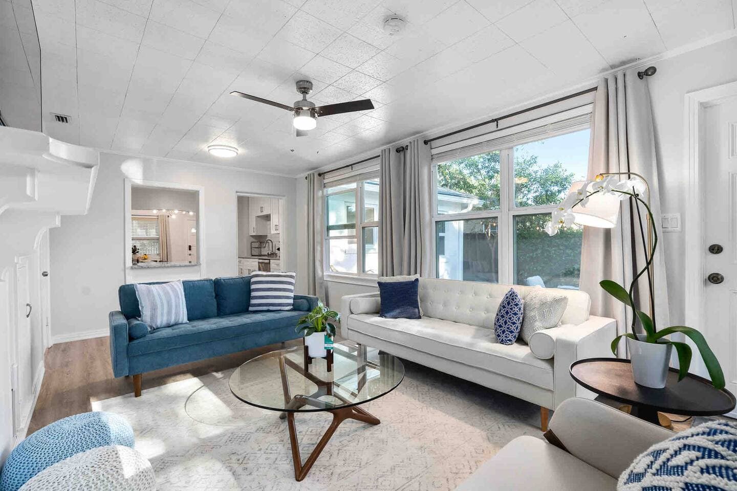 Open-concept living space with mid-century modern decor – Falling Moss Villa