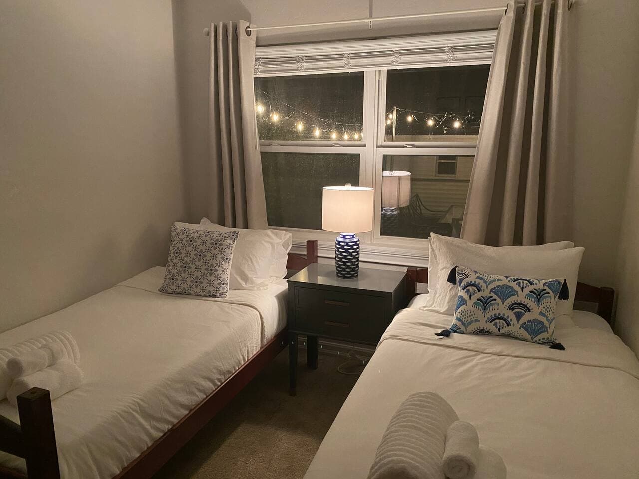 Cozy evening window view with warm interior lighting and designer curtains