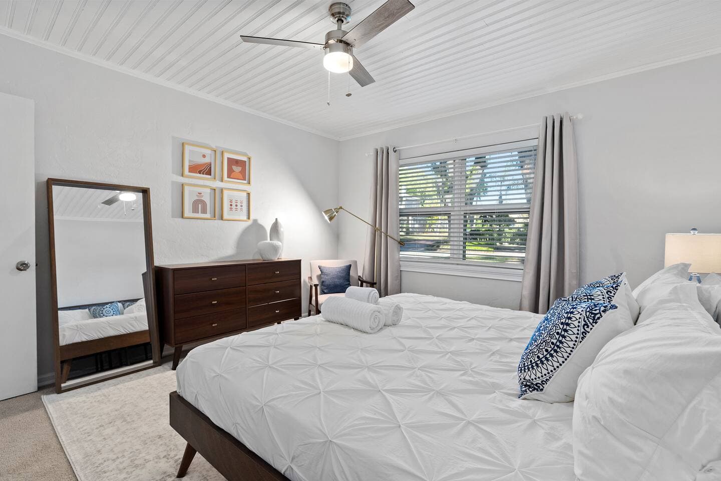 Minimalist guest bedroom with natural light and hardwood floors – The Falling Moss Villa